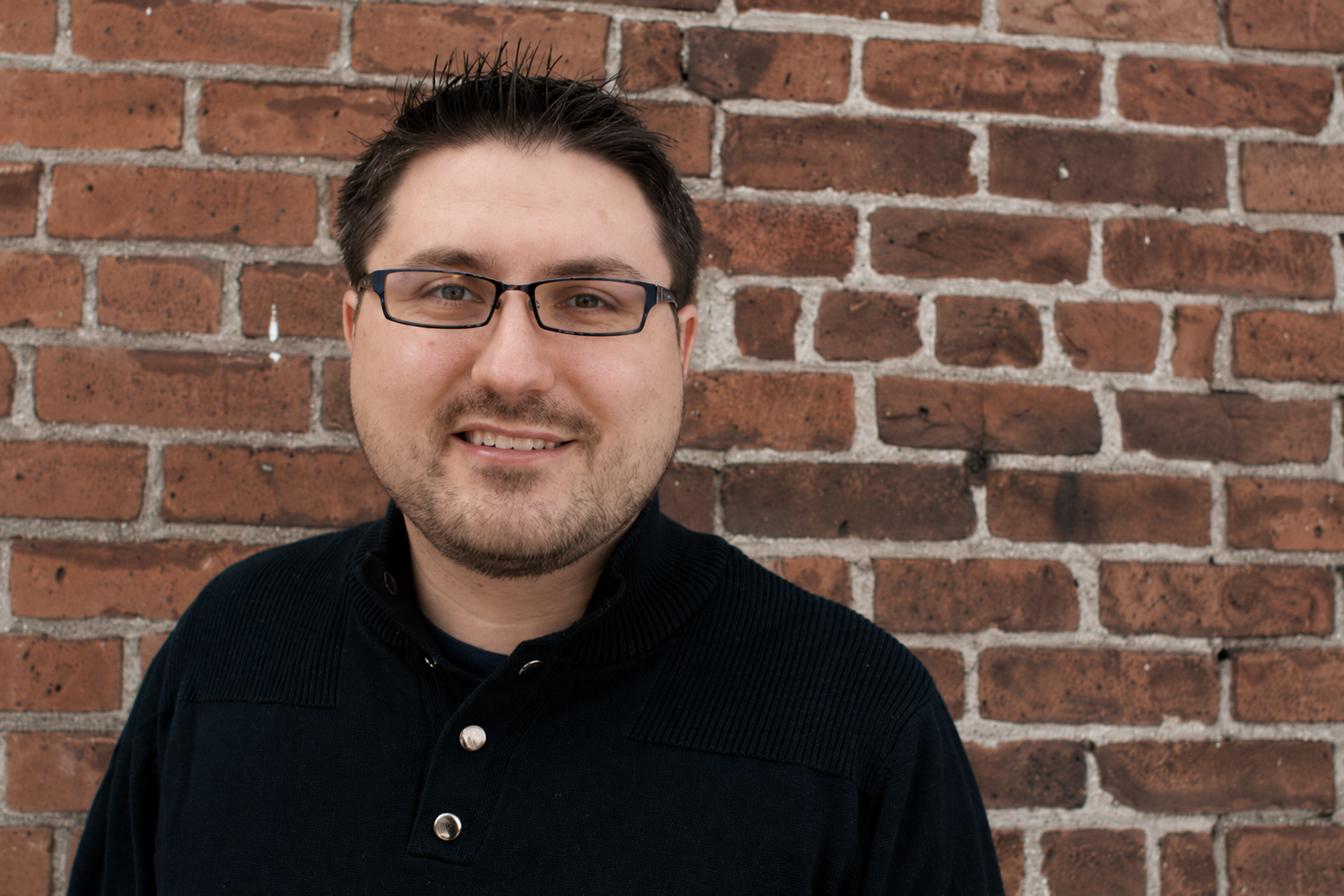 Portrait of Wes Weingartner against a brick wall